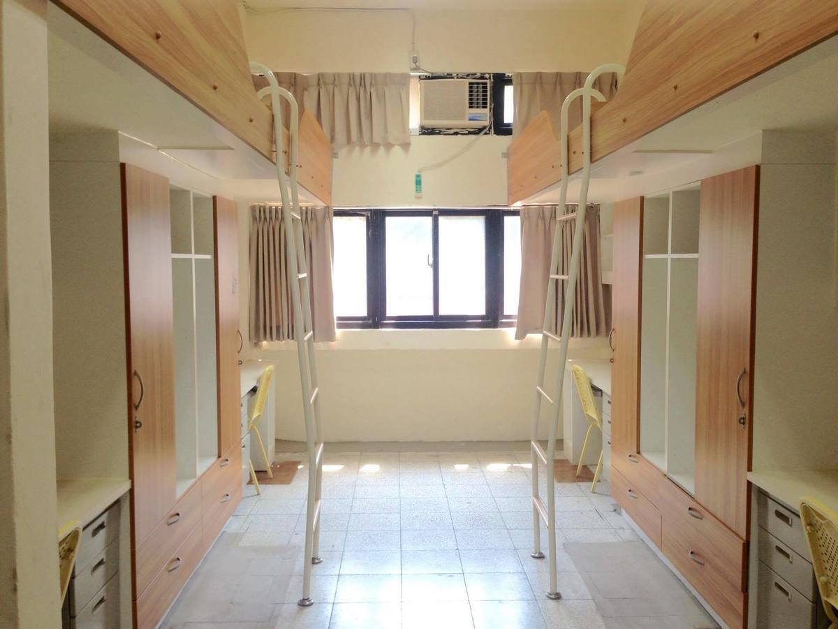 Tables, a kitchen counter and vending machines in a dormitory common area
